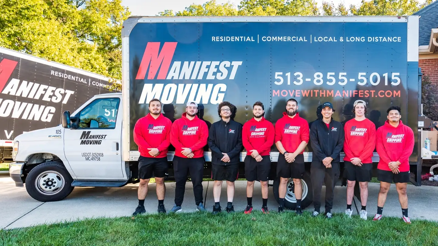Manifest Moving crew standing together in front of their moving truck