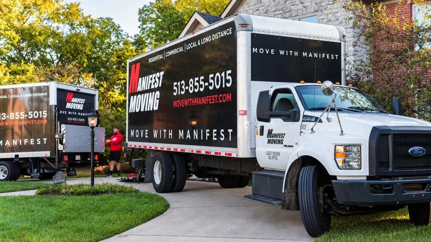 Manifest Moving trucks parked in a residential driveway